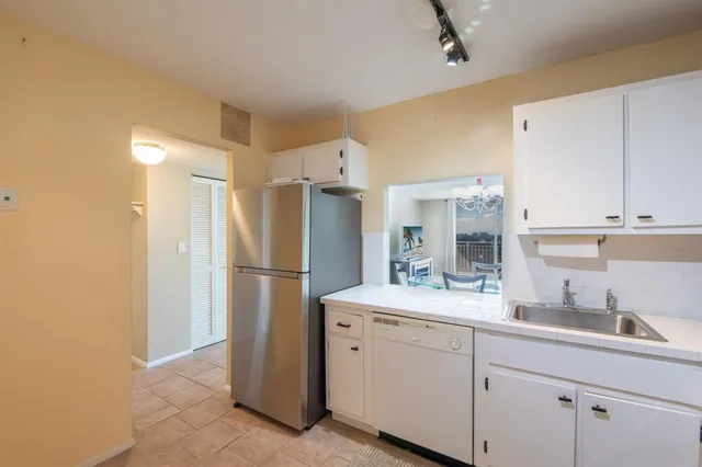 a kitchen with a sink and refrigerator