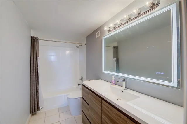 a spacious bathroom with a double vanity sink and a mirror
