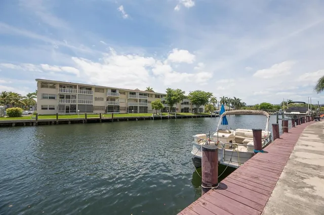 a view of a lake with boats and large trees