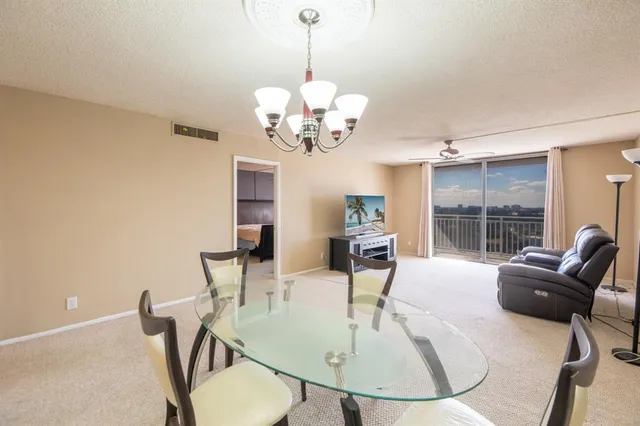 a view of a dining room with furniture wooden floor and chandelier