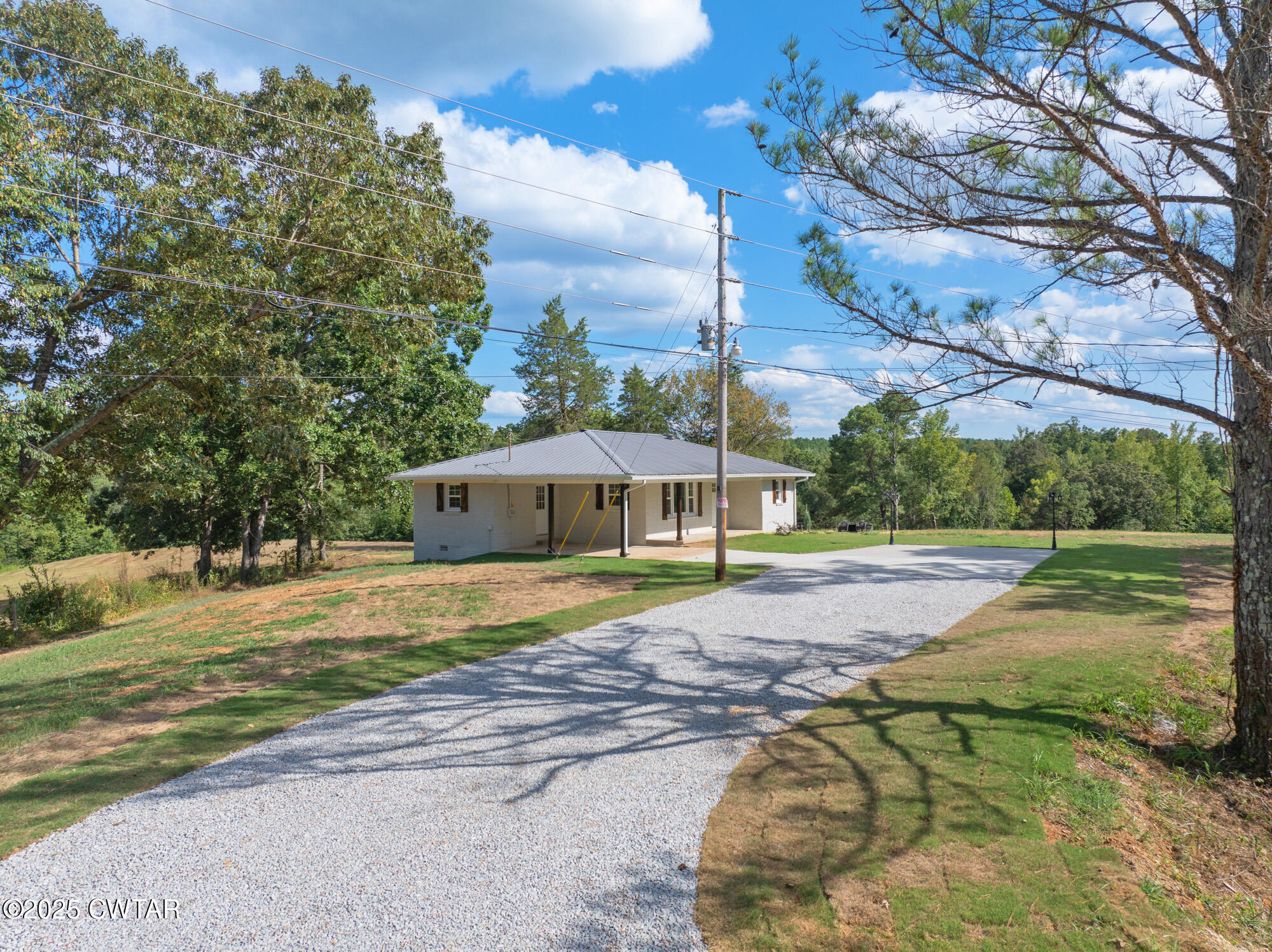 7371 Brooksie Thompson Road Bath Springs, TN 38311 - Photo 2 of 25 a swimming pool with trees in the background