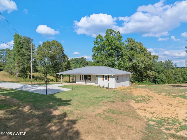 a kitchen with a refrigerator a sink dishwasher a stove and white cabinets with wooden floor