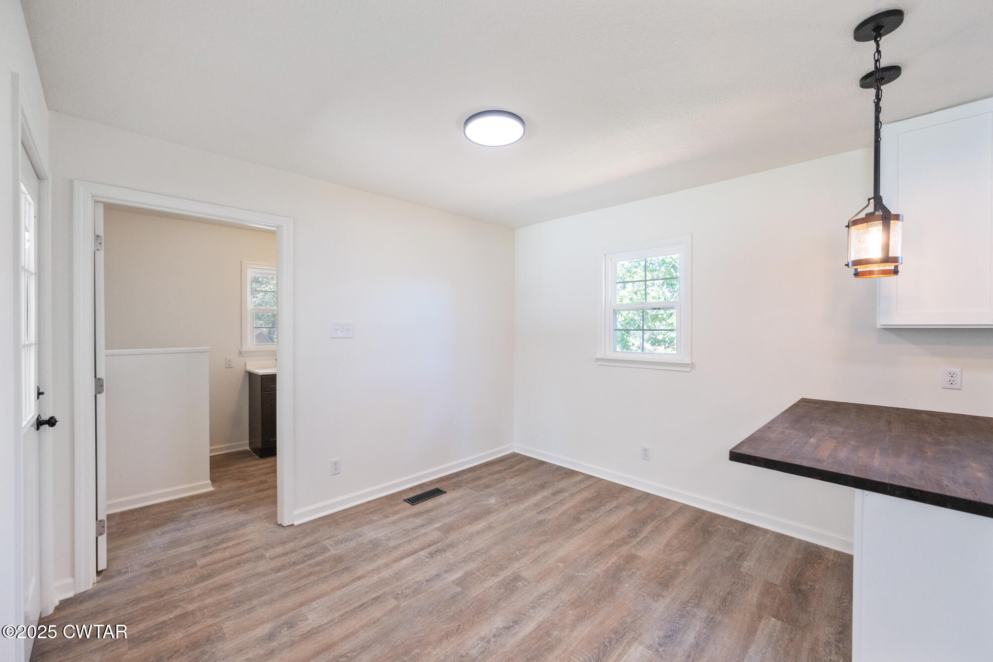 7371 Brooksie Thompson Road Bath Springs, TN 38311 - Photo 8 of 25 a view of empty room with wooden floor and fan