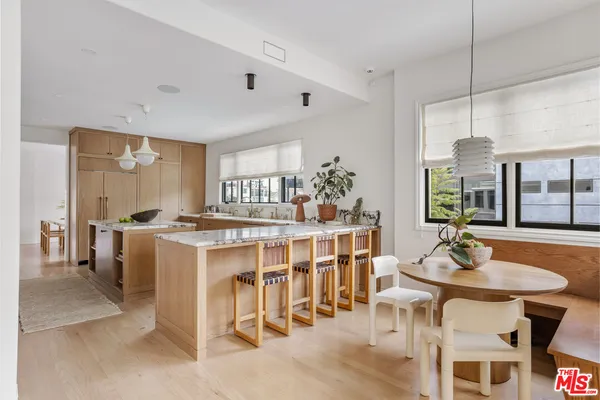 a kitchen with stainless steel appliances granite countertop a stove and a white cabinets