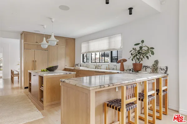 a dining room with wooden floor and breakfast area