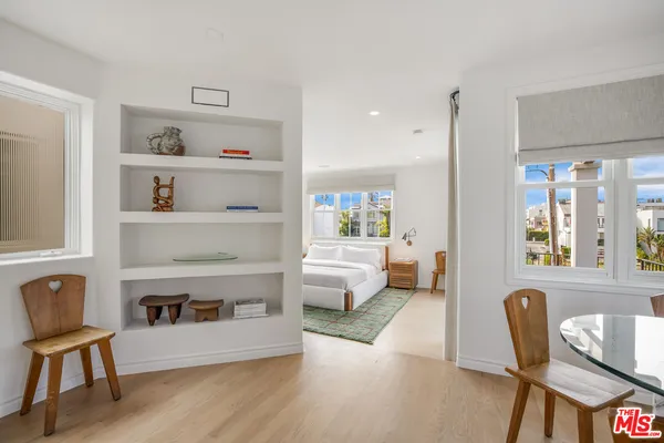 a spacious bedroom with a large bed and a large window