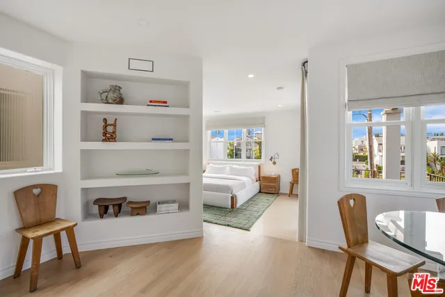 a spacious bedroom with a large bed and a large window