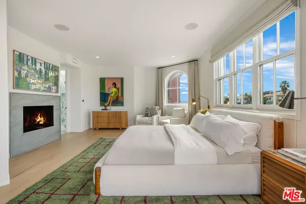 a spacious bathroom with a tub sink and mirror
