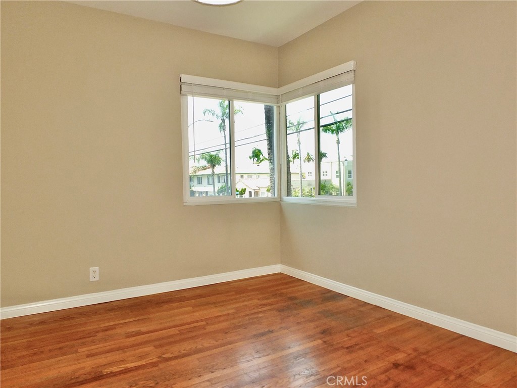 1808 East Appleton Street, Unit 7 Long Beach, CA 90802 - Photo 25 of 44 an empty room with wooden floor and windows