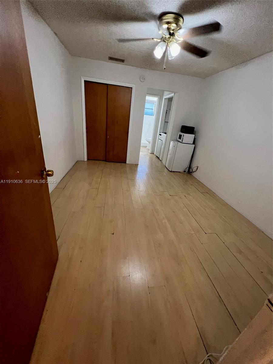 4841 Southwest 45th Avenue, Unit 3 Hollywood, FL 33314 - Photo 3 of 6 wooden floor in an empty room with a window