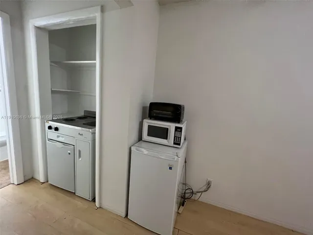 a view of storage and utility room with washer and dryer