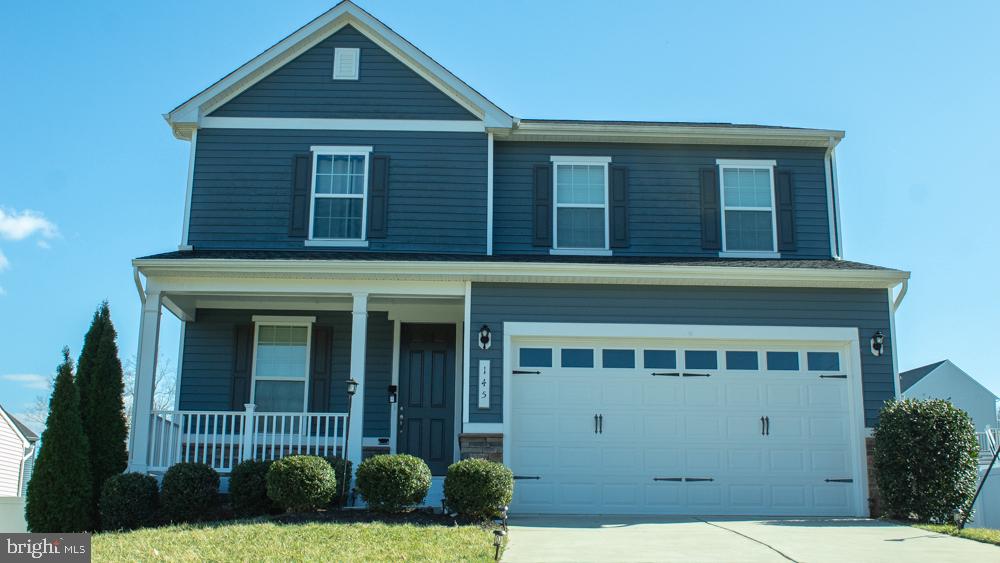 Charming blue home with inviting porch.