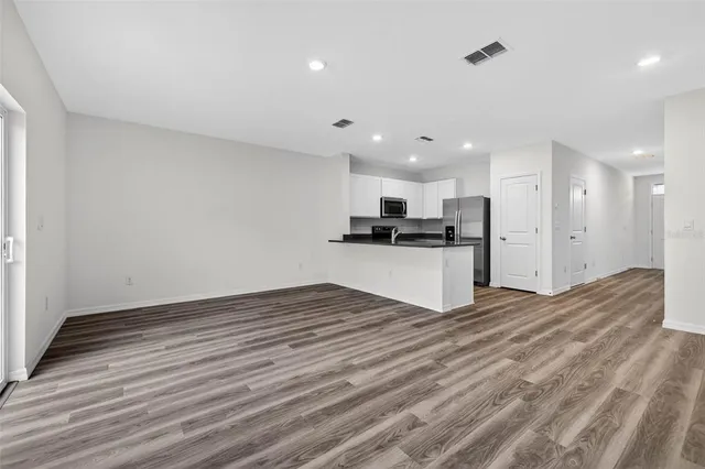 a view of kitchen with wooden floor and a sink