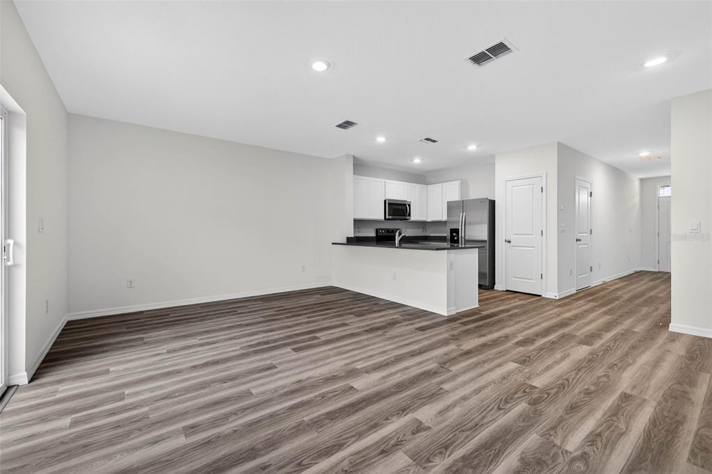 31264 Paper Birch Street Wesley Chapel, FL 33545 - Photo 11 of 32 a view of kitchen with wooden floor and a sink