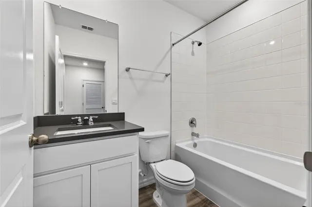 a bath room with a sink a toilet and a mirror