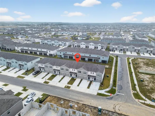 an aerial view of residential houses with outdoor space