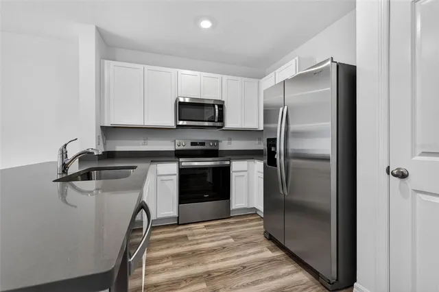 a kitchen with a refrigerator sink and microwave