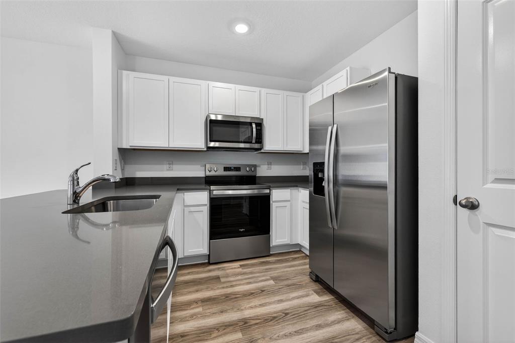 31264 Paper Birch Street Wesley Chapel, FL 33545 - Photo 5 of 32 a kitchen with a refrigerator sink and microwave