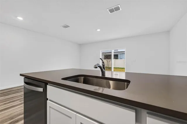 a kitchen with a sink and cabinets