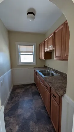 a kitchen with stainless steel appliances granite countertop a sink stove and cabinets