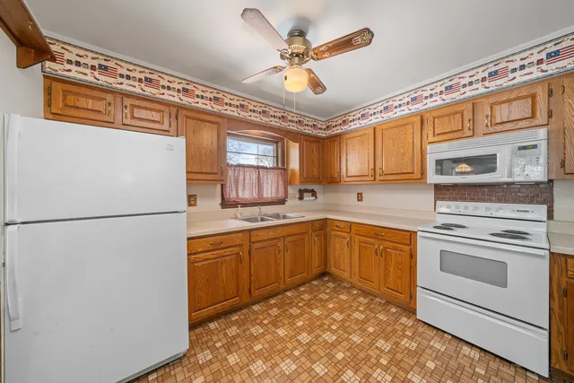 a kitchen with stainless steel appliances granite countertop cabinets and a refrigerator