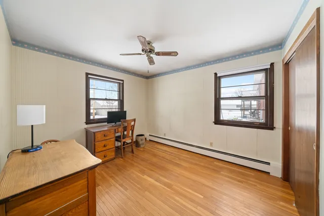 a bedroom with a bed and a flat tv screen on a dresser