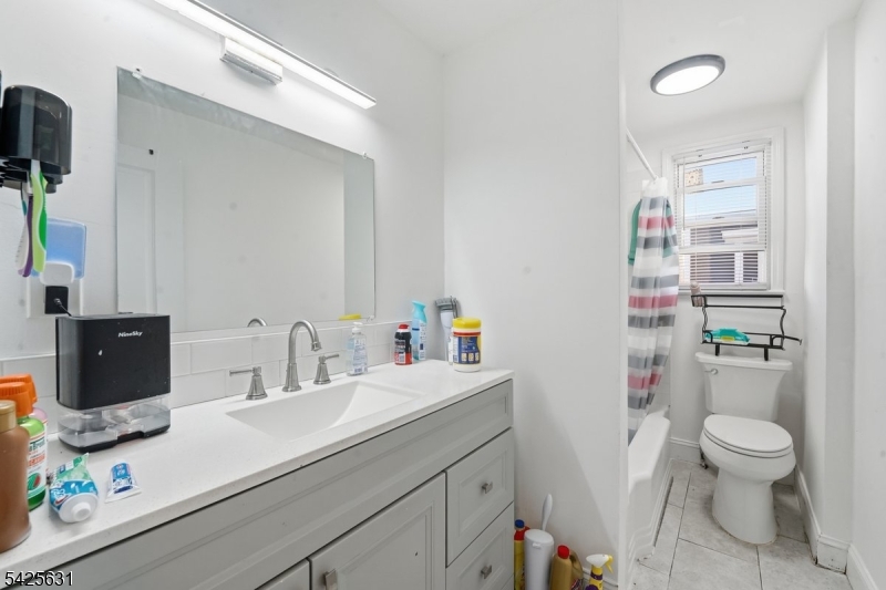 60 Westervelt Place Lodi, NJ 07644 - Photo 20 of 48 a bathroom with a sink toilet and shower