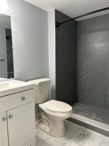 a white toilet and shower