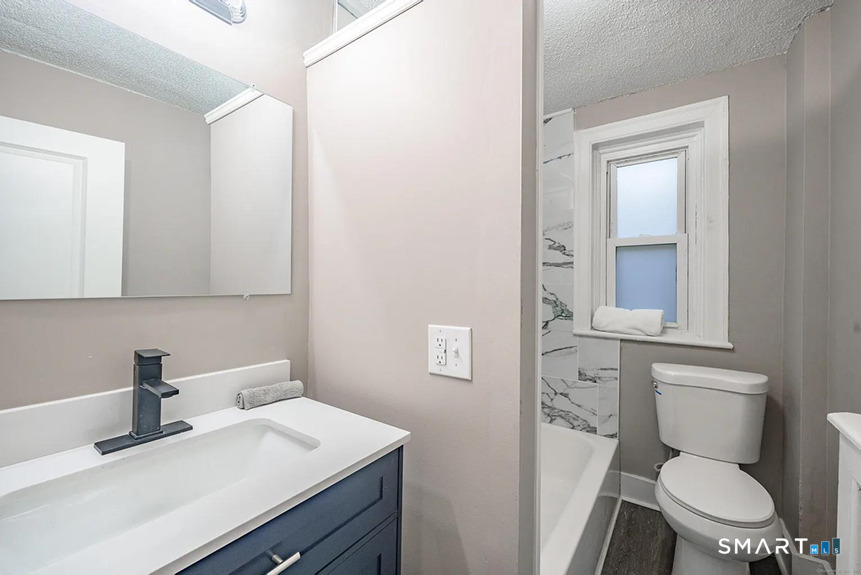 73 Silver Street Middletown, CT 06457 - Photo 22 of 30 a bathroom with a toilet sink vanity and mirror