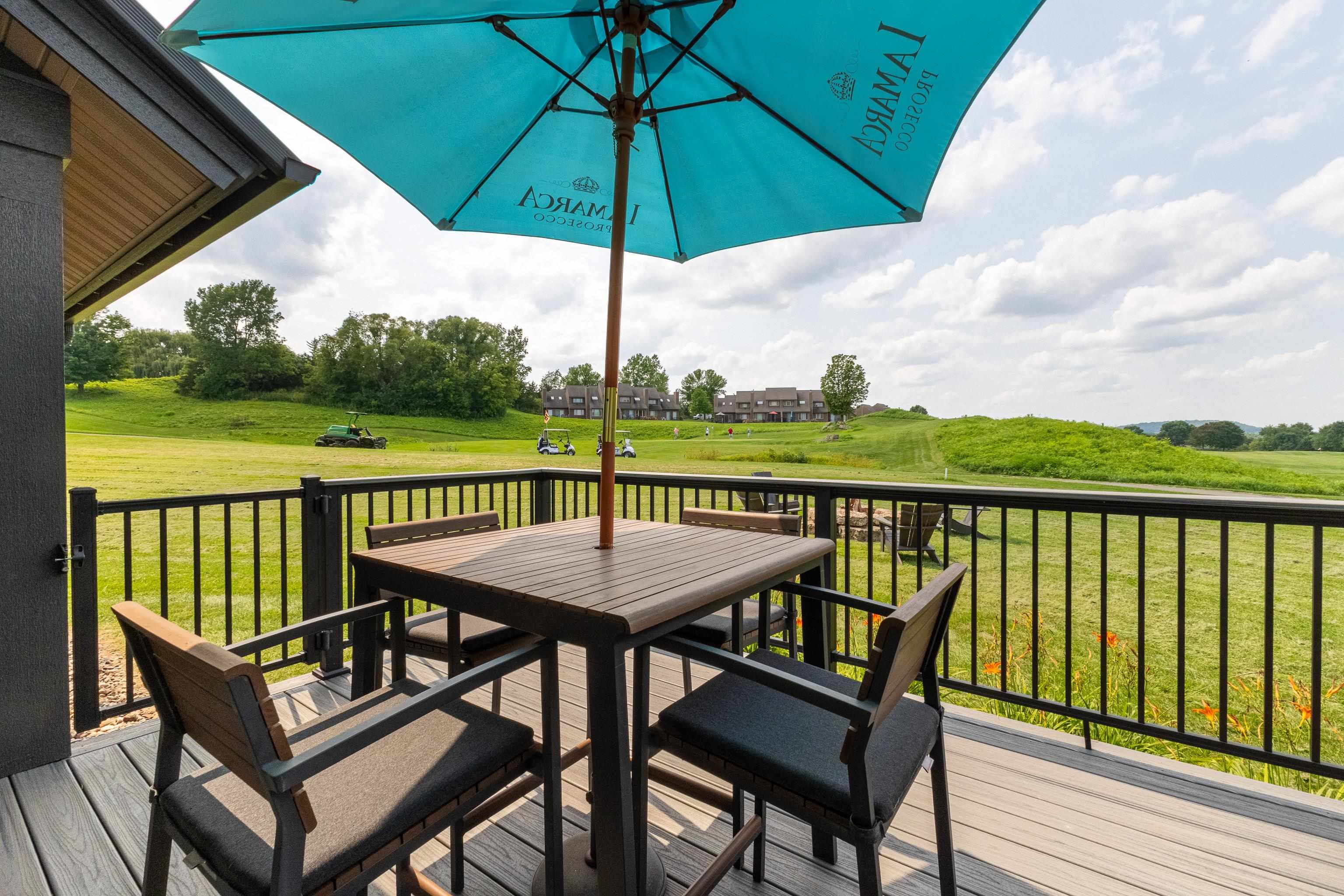 6 Hickory Trail Galena, IL 61036 - Photo 22 of 67 a view of a balcony with furniture and umbrella