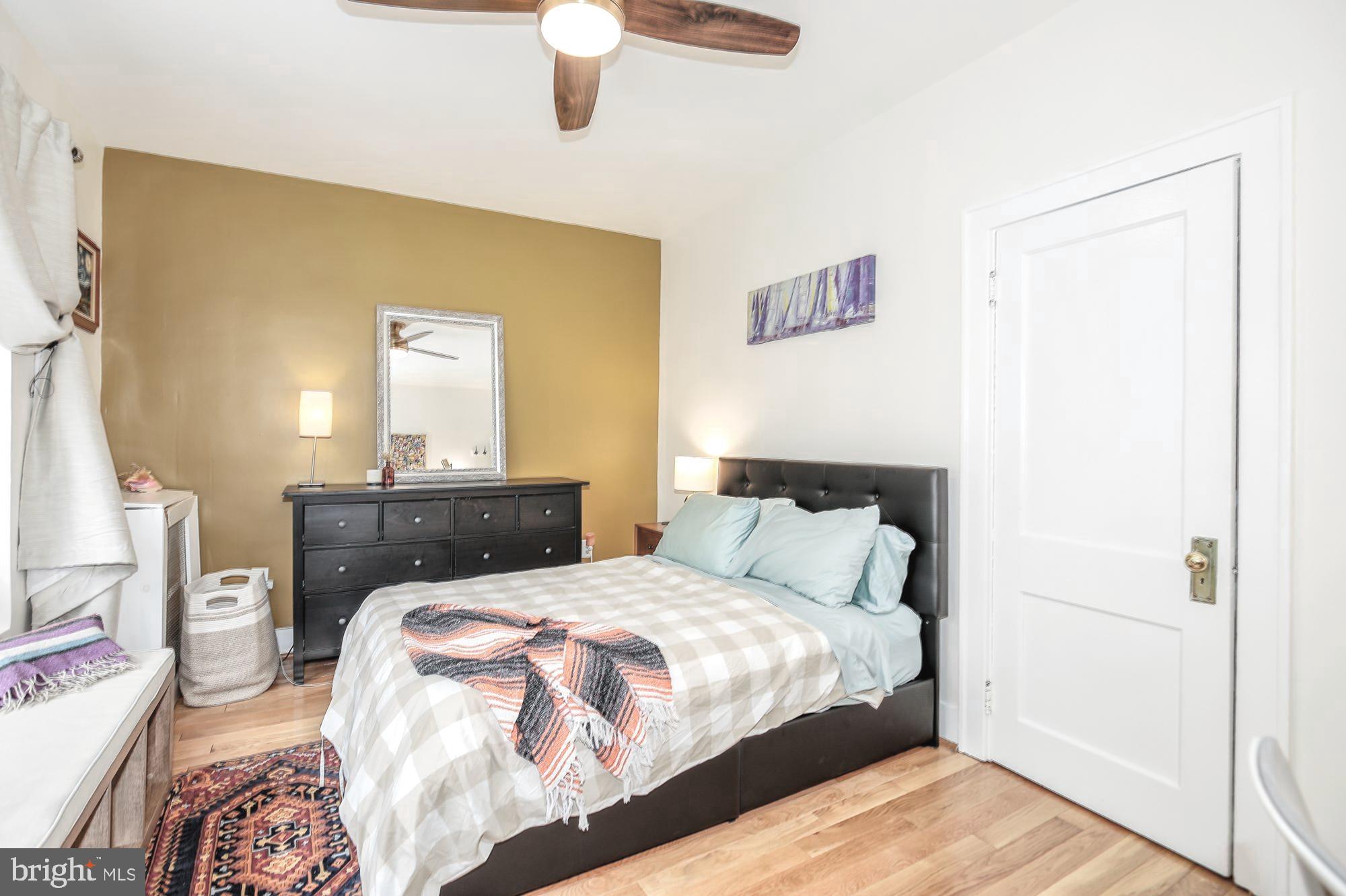 1820 Clydesdale Place Northwest, Unit 103 Washington, DC 20009 - Photo 11 of 14 a bedroom with a bed and a chandelier