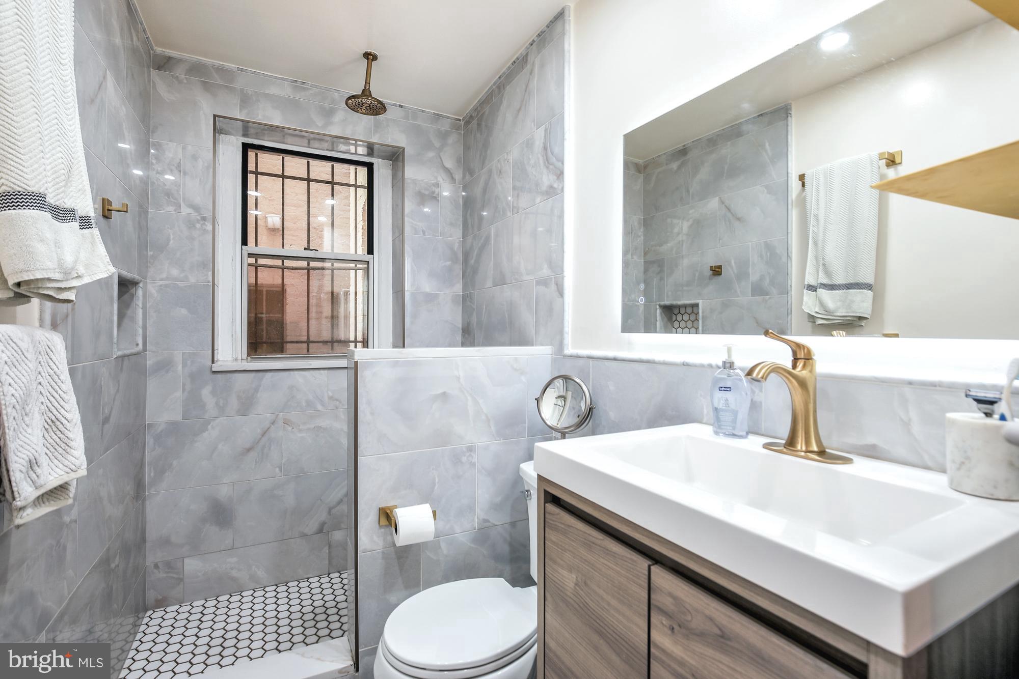 1820 Clydesdale Place Northwest, Unit 103 Washington, DC 20009 - Photo 14 of 14 a bathroom with a sink toilet and shower