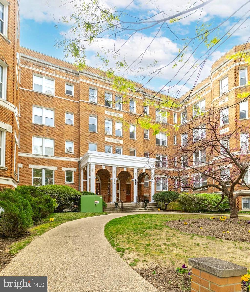 1820 Clydesdale Place Northwest, Unit 103 Washington, DC 20009 - Photo 2 of 14 a front view of a residential apartment building with a yard