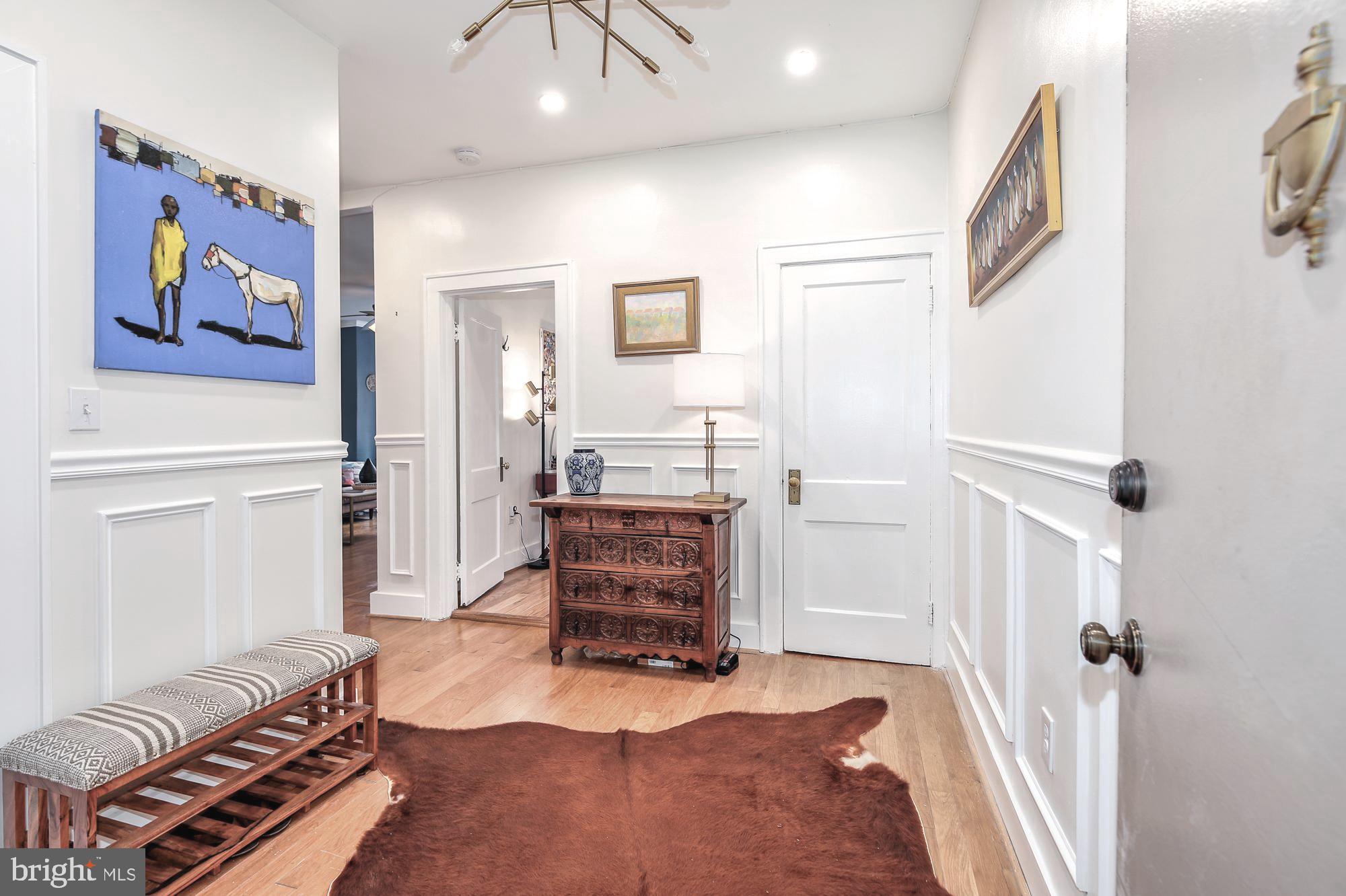 1820 Clydesdale Place Northwest, Unit 103 Washington, DC 20009 - Photo 5 of 14 a living room with furniture and a wooden floor