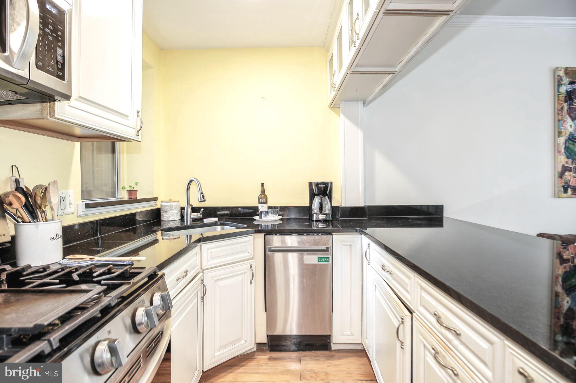 1820 Clydesdale Place Northwest, Unit 103 Washington, DC 20009 - Photo 9 of 14 a kitchen with stainless steel appliances granite countertop a stove and a sink