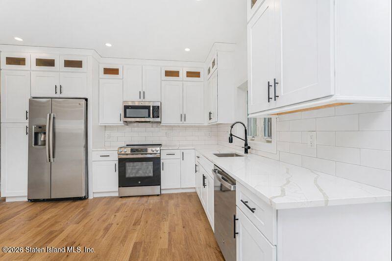 911 Rathbun Avenue Staten Island, NY 10309 - Photo 9 of 30 a kitchen with granite countertop a sink stove and refrigerator