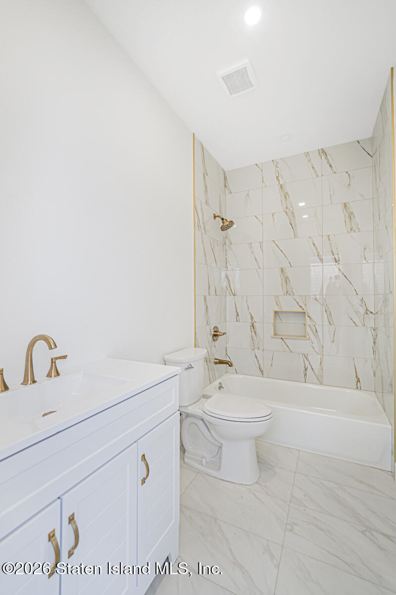 911 Rathbun Avenue Staten Island, NY 10309 - Photo 10 of 30 a bathroom with a sink a toilet and shower
