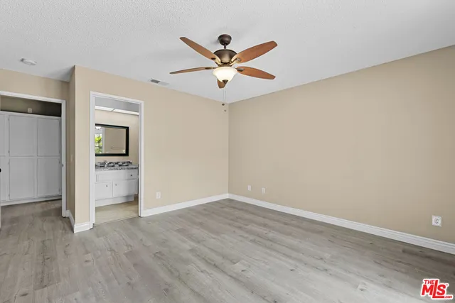 wooden floor in a room with a ceiling fan