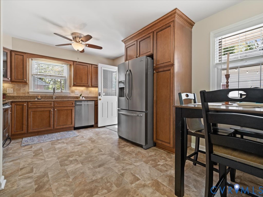 1455 Robindale Road Richmond, VA 23235 - Photo 8 of 29 a kitchen with stainless steel appliances granite countertop a sink stove and refrigerator