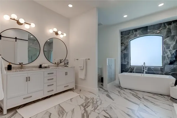 a bathroom with double vanity sinks and a mirror