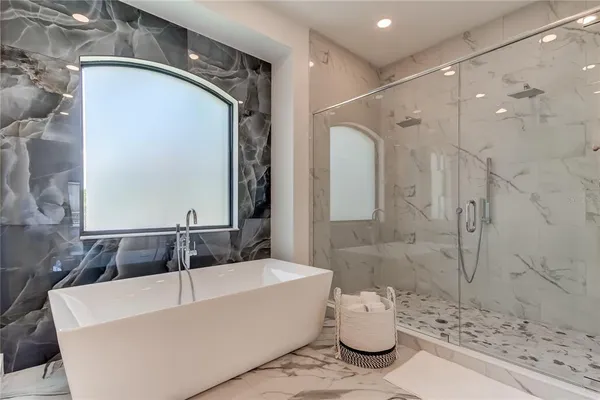 a bathroom with a bathtub sink and mirror