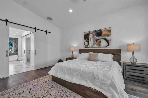 a bedroom with a bed and a chair