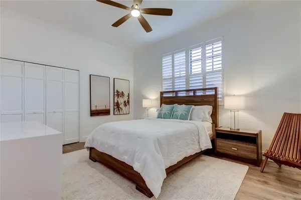 a bedroom with a bed and painting on the wall