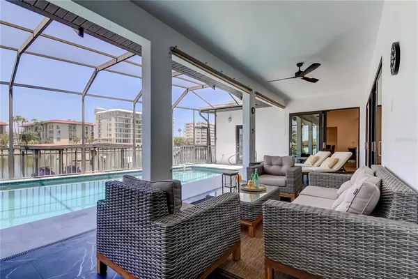 a kitchen with a sink a stove and a view of living room