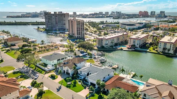 an aerial view of residential houses with outdoor space and ocean view