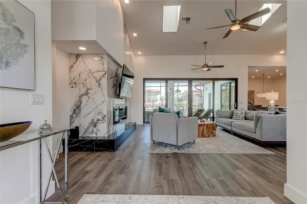 a living room with fireplace furniture and a wooden floor