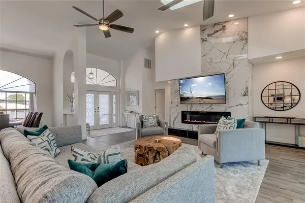 a living room with furniture a fireplace and a flat screen tv