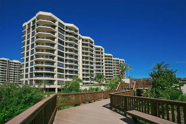 a view of a balcony with a yard