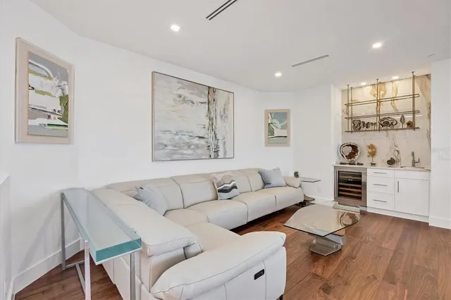 a living room with furniture and a painting on the wall