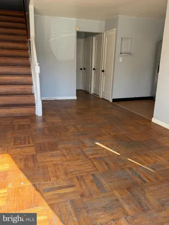 a view of an empty room with stairs and ventilation